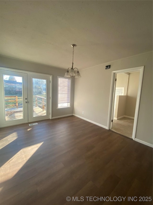 interior space featuring a chandelier and dark hardwood / wood-style flooring