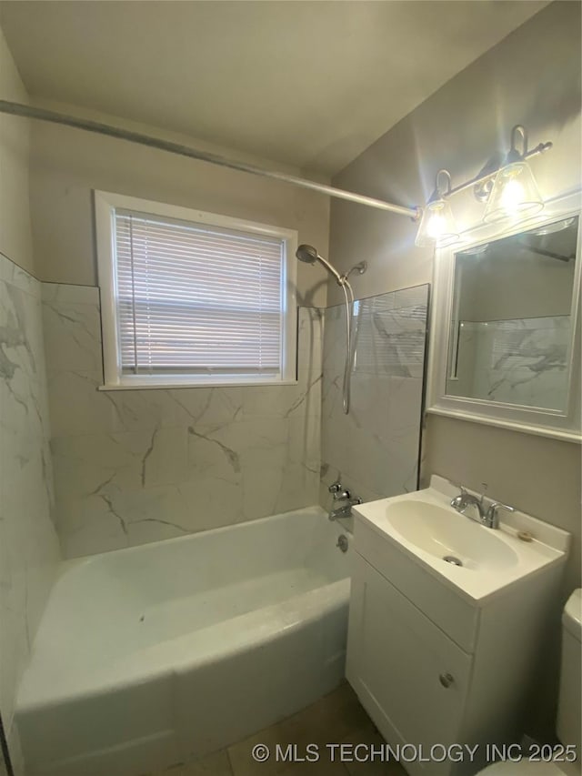 full bathroom featuring vanity, toilet, and tiled shower / bath