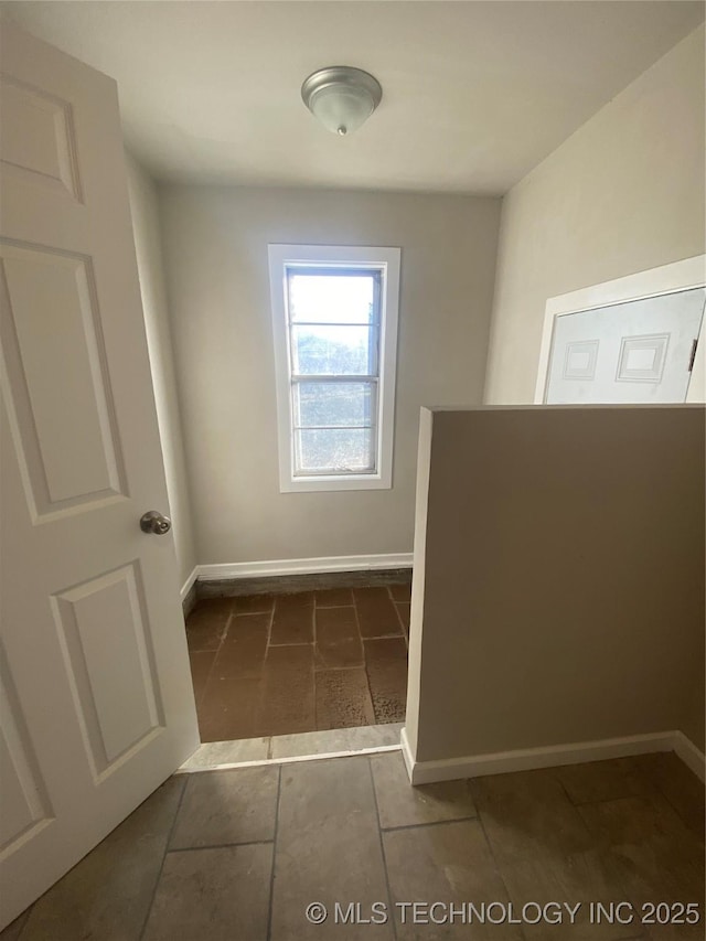 interior space featuring dark tile patterned flooring