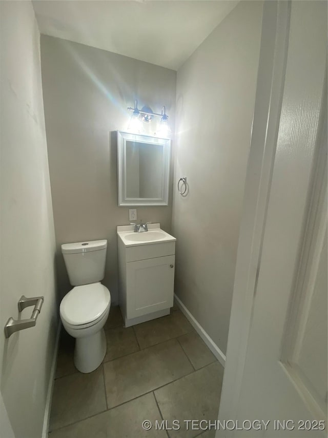 bathroom with tile patterned floors, vanity, and toilet