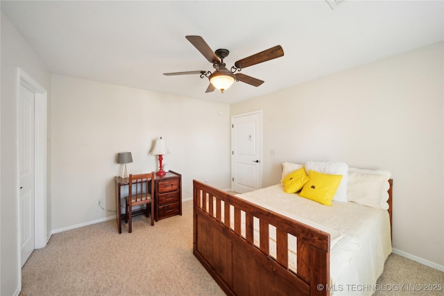 bedroom with ceiling fan, light colored carpet, and a closet