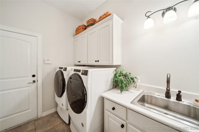 laundry room featuring sink, light tile patterned floors, cabinets, and independent washer and dryer