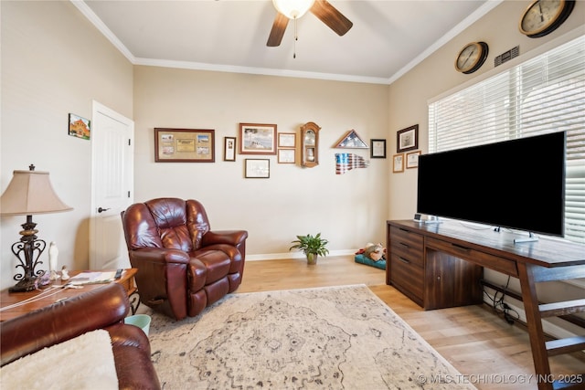 living room featuring ceiling fan, light hardwood / wood-style floors, and ornamental molding