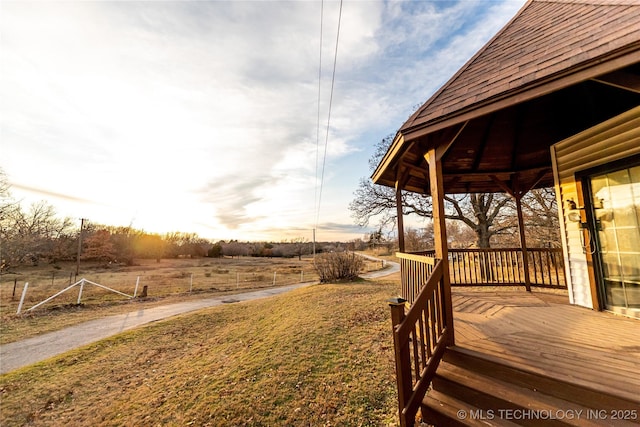 view of yard featuring a rural view and a deck