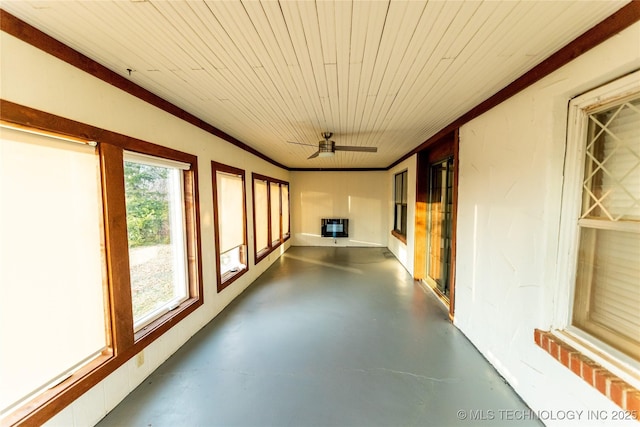 unfurnished sunroom with ceiling fan and wood ceiling