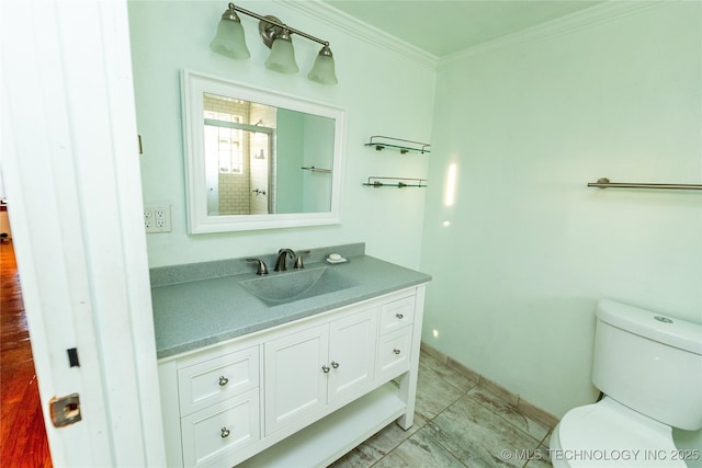 bathroom featuring vanity, toilet, and ornamental molding