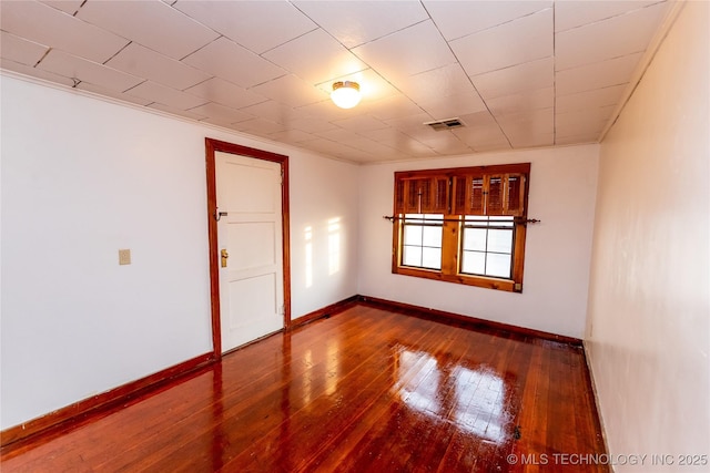 empty room with hardwood / wood-style flooring