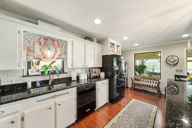 kitchen featuring white cabinetry, sink, dark wood-type flooring, a textured ceiling, and black appliances