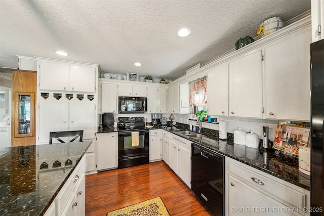 kitchen with white cabinets and black appliances