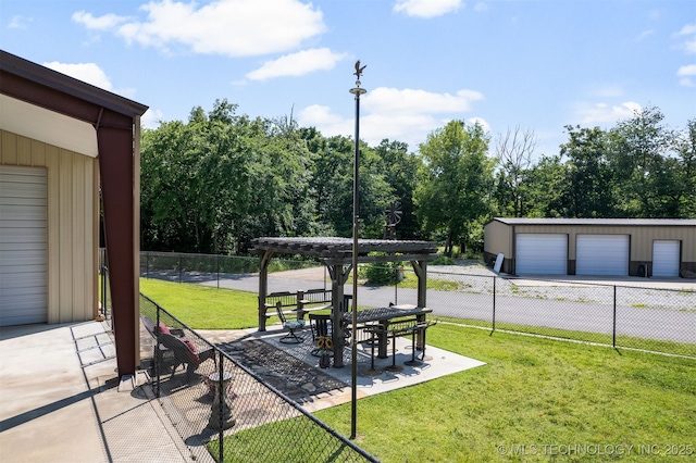 view of yard featuring a patio, an outdoor structure, and a garage