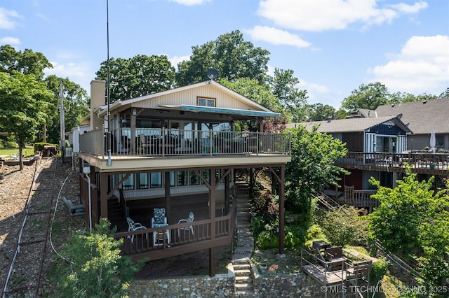 back of house featuring a deck