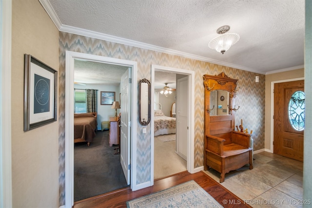 foyer featuring a textured ceiling and ornamental molding