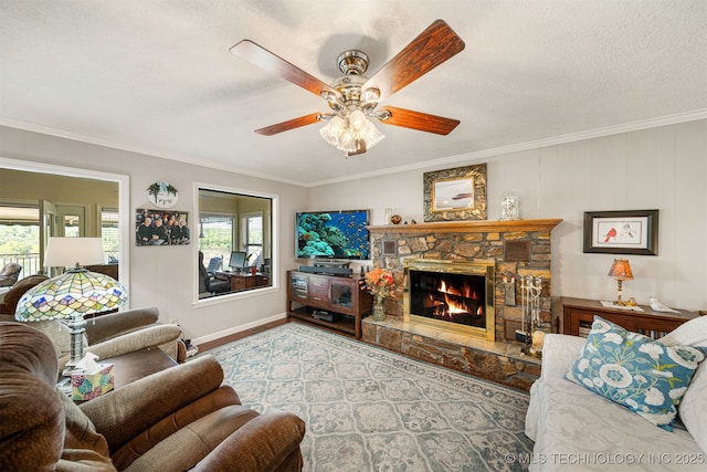 living room with a wealth of natural light, a fireplace, and crown molding