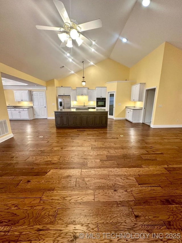 kitchen with dark brown cabinetry, white cabinetry, stainless steel refrigerator with ice dispenser, a kitchen island, and hardwood / wood-style flooring