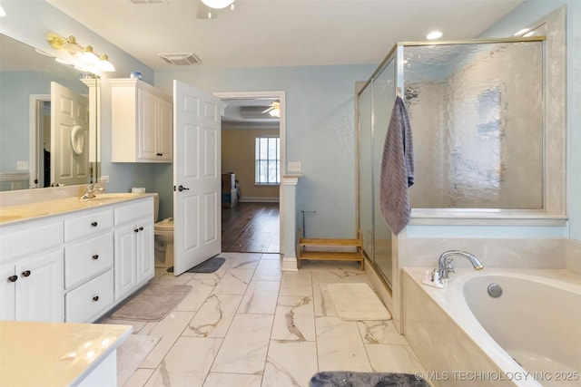 full bathroom with shower with separate bathtub, vanity, toilet, and ceiling fan