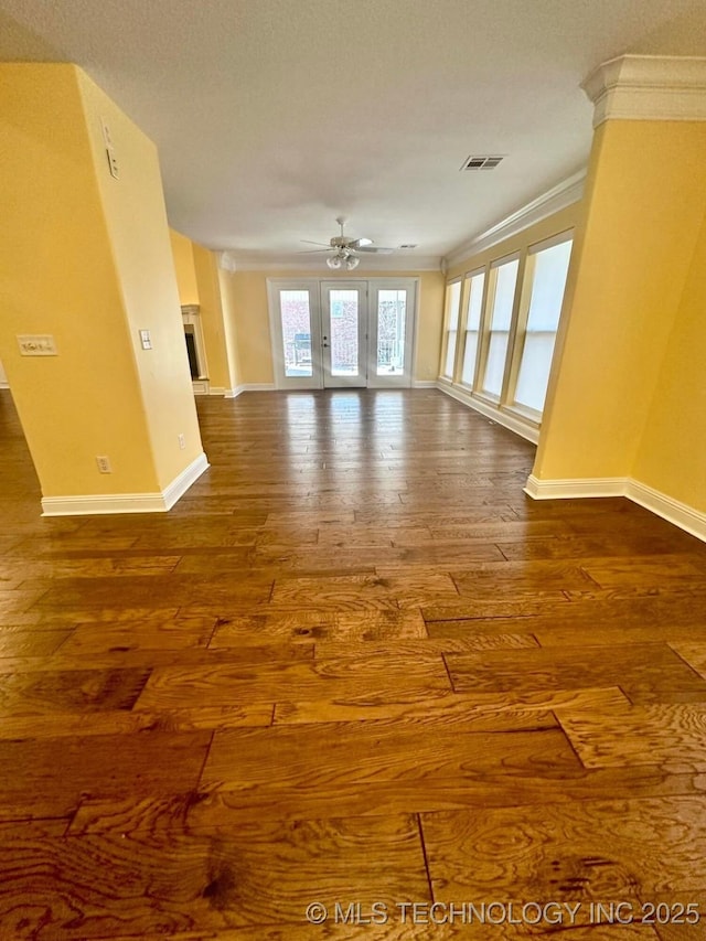 spare room with hardwood / wood-style flooring, ceiling fan, ornamental molding, and french doors