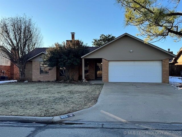 single story home featuring a garage and a front lawn