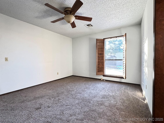 unfurnished room with ceiling fan, carpet, and a textured ceiling