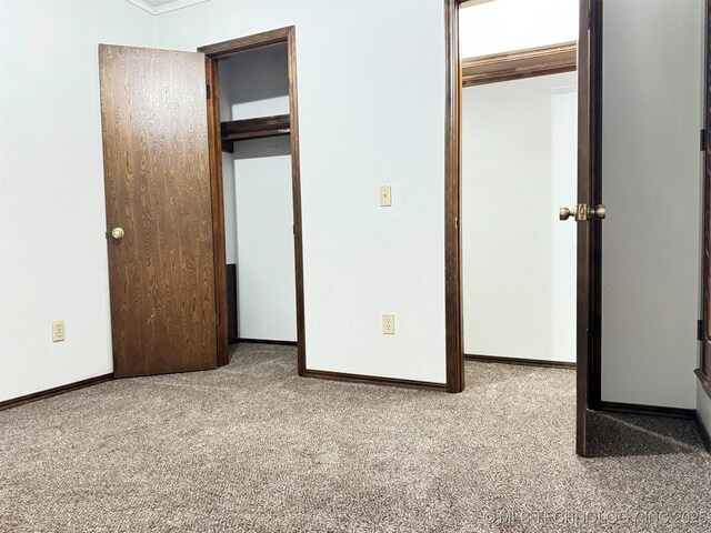 unfurnished bedroom featuring a closet and carpet floors