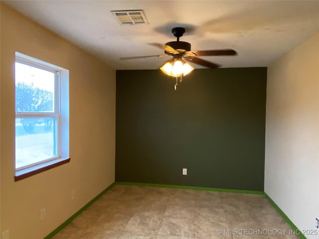 unfurnished room featuring ceiling fan