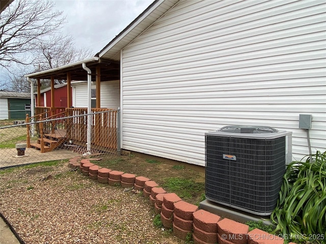 view of side of home featuring cooling unit