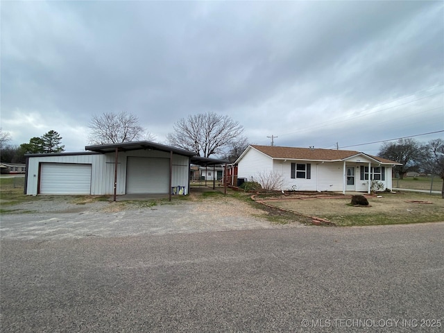 ranch-style home with a carport, a porch, and a garage