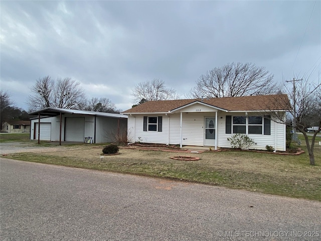 view of front of property with a front yard and a garage