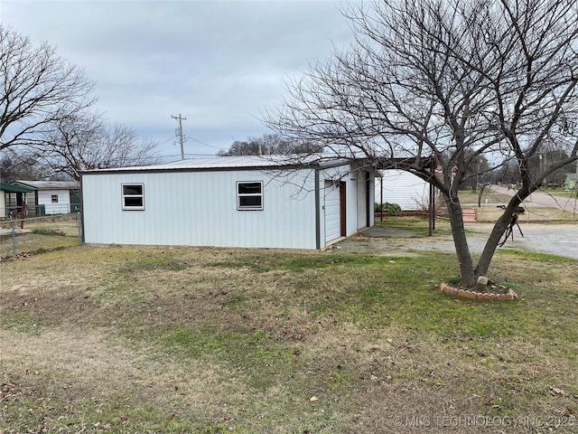 view of outdoor structure with a yard and a garage