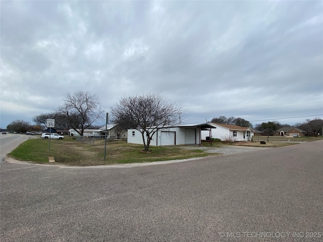 view of front of home featuring a garage and a front lawn