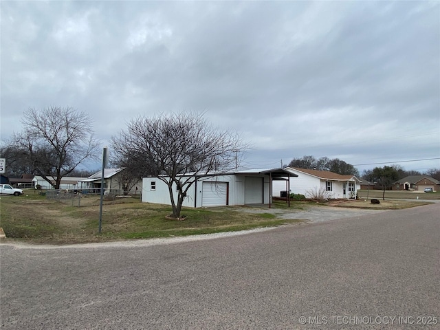 view of front of house with a garage and a front lawn