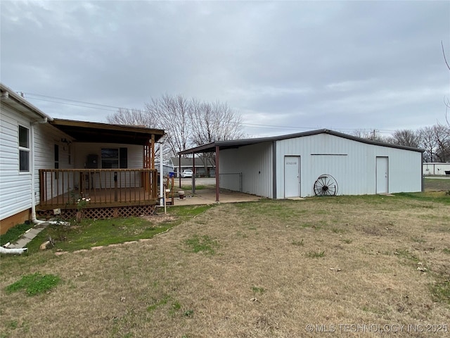 view of yard featuring an outdoor structure and a carport