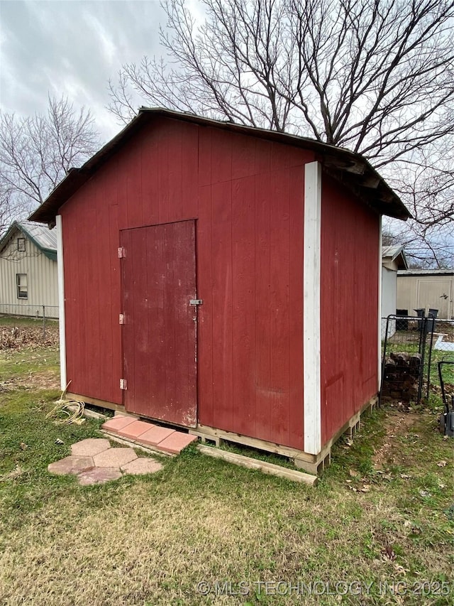 view of outbuilding with a lawn