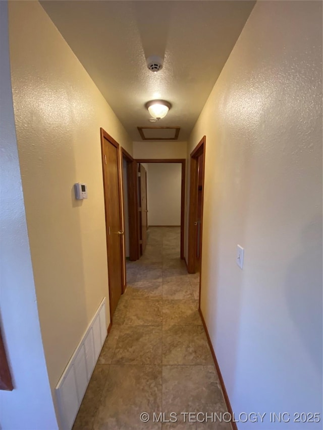 hall featuring a textured ceiling