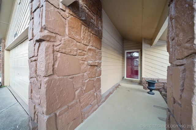 doorway to property with a garage