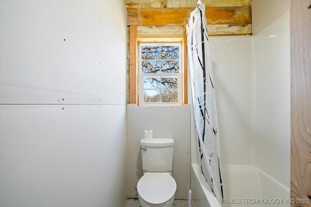 bathroom with shower / bath combo and toilet