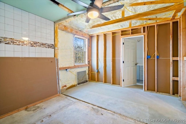 interior space with ceiling fan and concrete floors