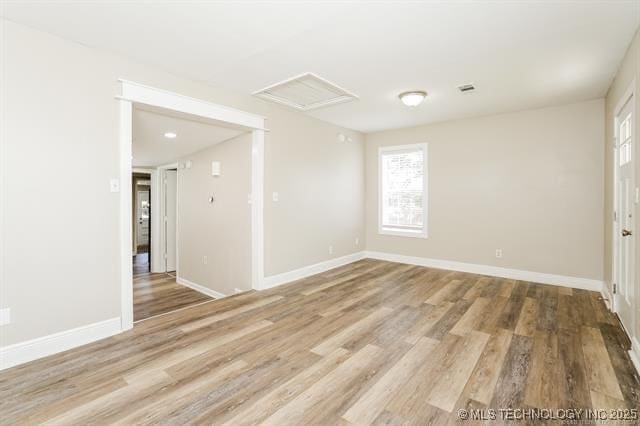 unfurnished room with hardwood / wood-style flooring