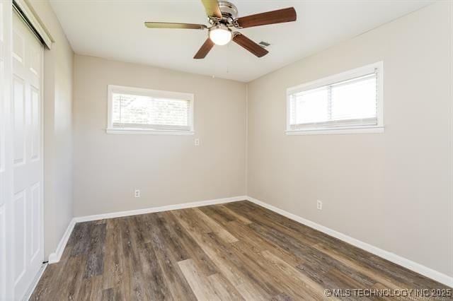 unfurnished room featuring ceiling fan and dark wood-type flooring