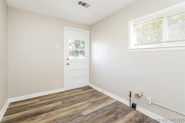 laundry area featuring dark hardwood / wood-style floors and a healthy amount of sunlight