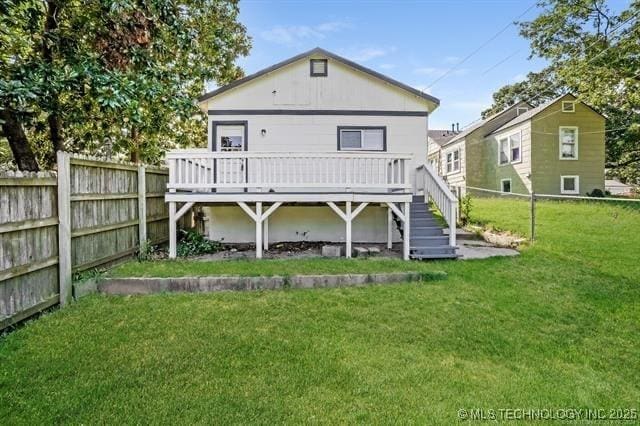 rear view of property with a lawn and a wooden deck