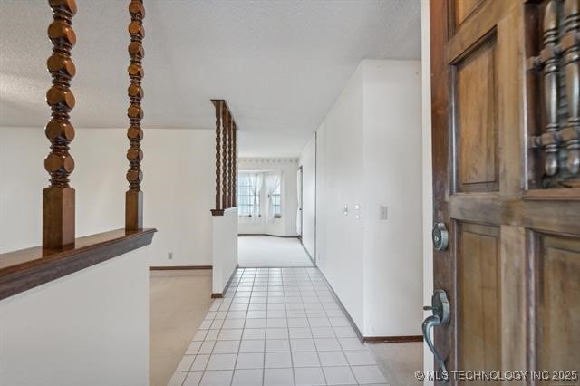 hallway with light tile patterned floors