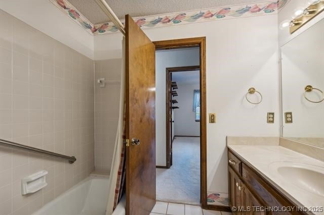 bathroom with tile patterned flooring, vanity, and shower / tub combo with curtain