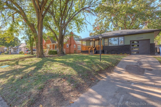 single story home featuring a garage and a front lawn