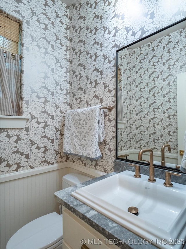 bathroom featuring vanity and toilet