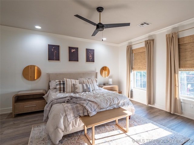 bedroom featuring ceiling fan, wood-type flooring, and crown molding