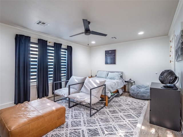 bedroom featuring hardwood / wood-style floors, ceiling fan, and crown molding