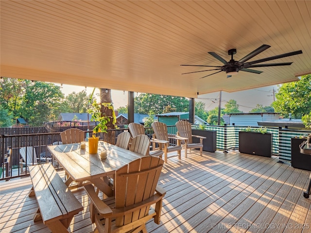 wooden deck with ceiling fan and a water view