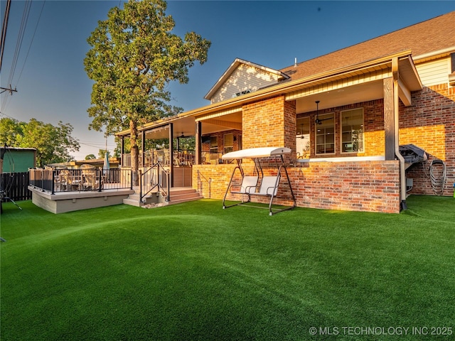 rear view of property featuring a yard