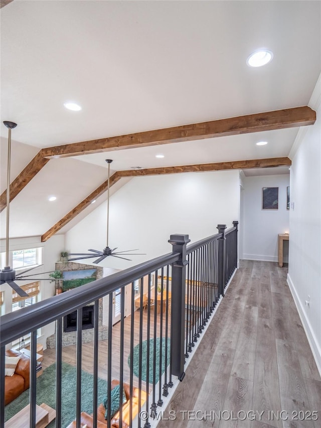 corridor with lofted ceiling with beams and wood-type flooring