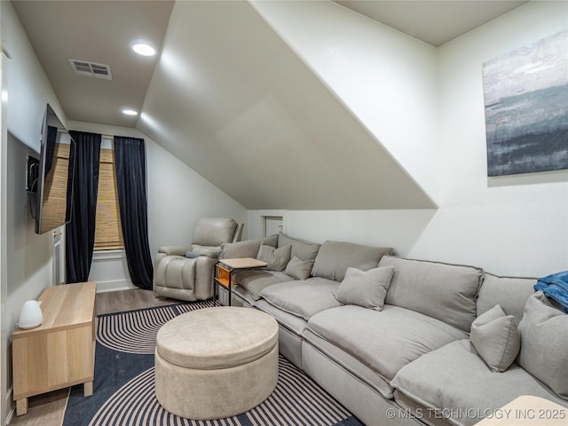 living room with wood-type flooring and vaulted ceiling